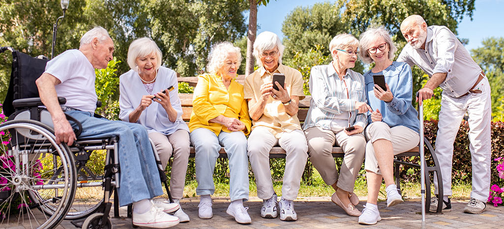 Senior citizens sitting on a park bench on a sunny day
